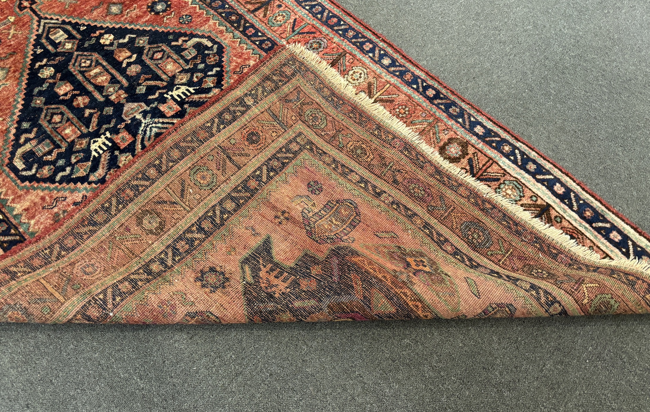 An Heriz red ground medallion rug 280 x 137cm